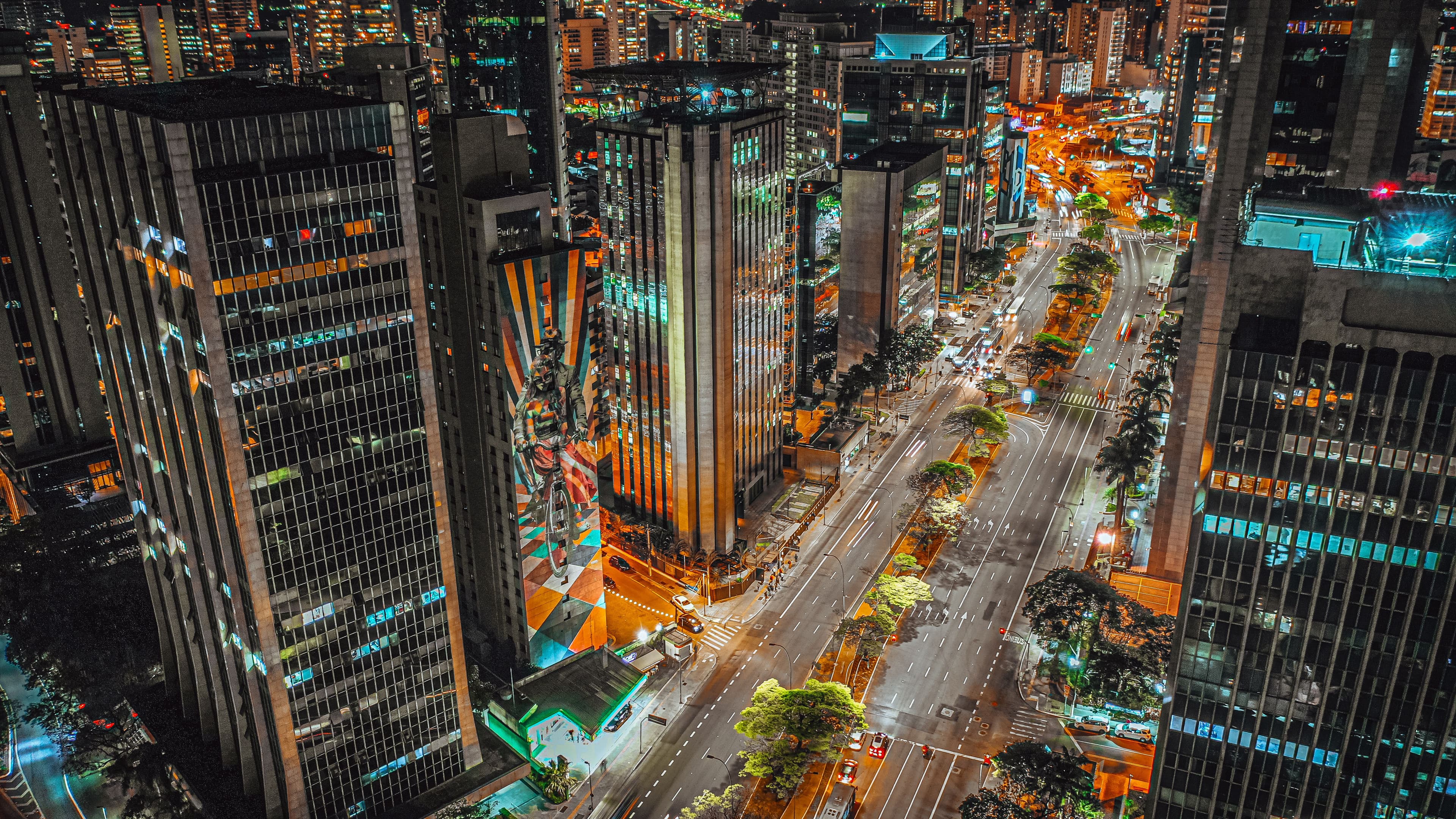 Aerial view of city streets and high-rise buildings at night